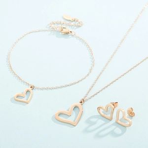 Three-piece rose gold jewelry set featuring heart-shaped necklace, bracelet and stud earrings