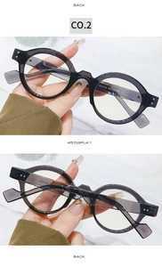 Detail view of transparent grey round glasses frames with metal hinges and size markings