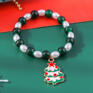 Detail of Christmas beaded bracelet with colorful beads and enamel Christmas tree pendant