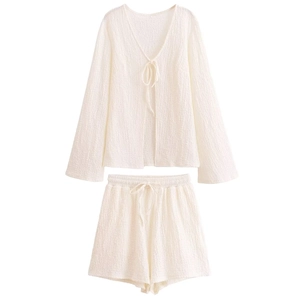 Women's white two-piece vacation set featuring a textured tie-front top and elastic shorts