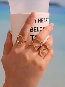 Detail of gold-plated ring set with 5A zircon stars and moon on hand in beach setting