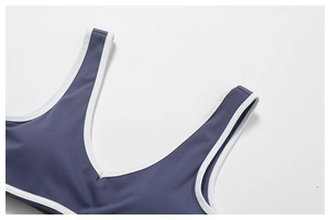 Macro shot of blue-gray sports bra with wide shoulder straps and white contrast trim