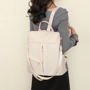 Chic quilted cream nylon backpack with diamond stitching and adjustable straps