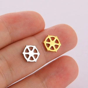 Close-up of small gold and silver hexagonal hollow charms for DIY jewelry making
