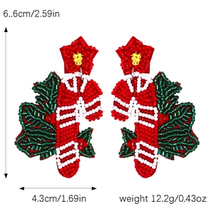 Detail view of handmade beaded Christmas candy cane earrings with size and weight metrics