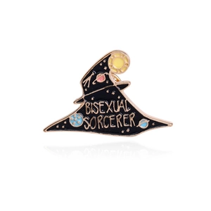 Detail of black enamel wizard hat brooch with gold trim and bisexual sorcerer text