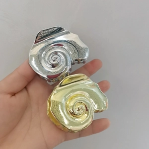 Minimalist spiral shell hair clips in gold and silver finish with geometric art design