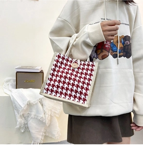 Classic houndstooth tote bag featuring durable cotton rope handles and wooden button closure