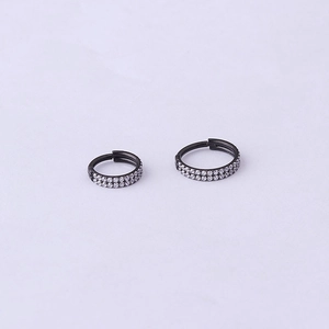 Detailed view of two sizes of black stainless steel rings with double rows of white zircons
