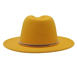 Close-up of mustard yellow wool felt fedora hat featuring a sleek gold metal band accessory