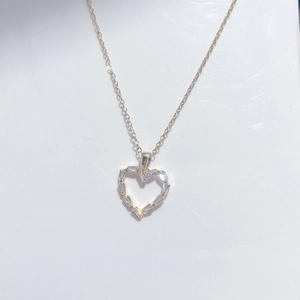 Polished gold heart pendant necklace with cubic zirconia baguette stones on O-chain