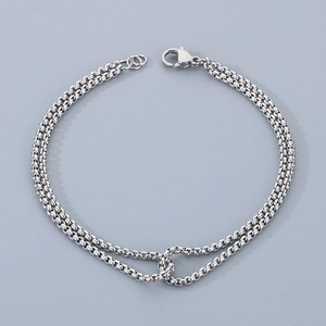Close-up of double-layer stainless steel rolo chain bracelet with lobster clasp