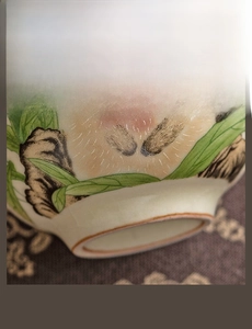 Detail of the Ru Kiln ceramic cup base showing the smooth foot and hand-painted bunny art