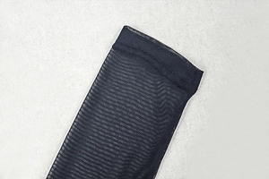 Close-up of black mesh fabric detail showing the intricate net texture and gathered seam