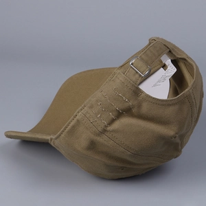 Detail view of khaki cotton baseball cap with distressed rip design and metal buckle
