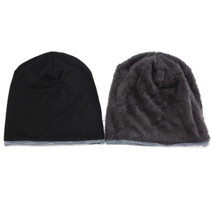 Detail of warm beanie hats showing black smooth fabric and grey plush inner textures