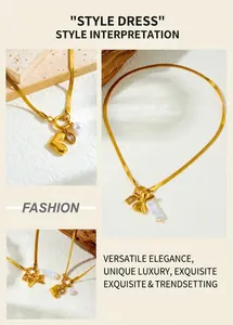 Detail of gold-plated stainless steel snake chain necklace with pearl heart and bow pendant