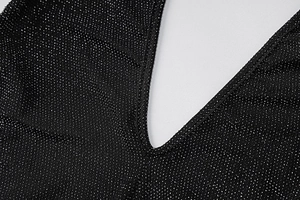 Detail of the glittering silver yarn fabric and precise V-neck stitching on this jumpsuit