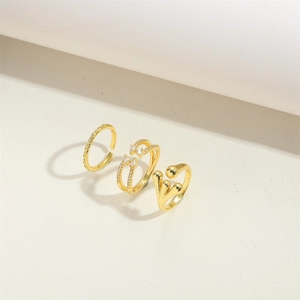 Three-piece minimalist gold ring set featuring zircon inlay and a unique heart shape