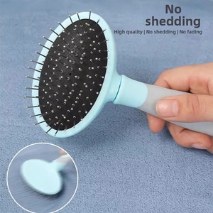 Detail of blue slicker brush with protective beads and non-slip handle for pet grooming