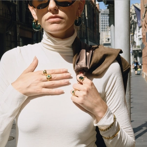 Street style shot of gold 18K stainless steel jewelry set with green malachite stones