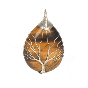 Detail of tiger eye stone pendant with handmade wire-wrapped tree of life design
