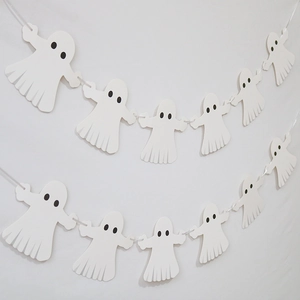 Close-up of white paper ghost banners for Halloween party wall decorations and bar decor