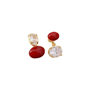 Vintage gold earrings with asymmetric red beads and oval cubic zirconia stones
