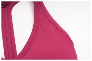 Macro shot of stitching details on the rose red yoga bra neckline and shoulder strap