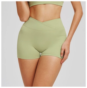 Detail of high waist yoga shorts featuring a criss-cross waistband and side pockets