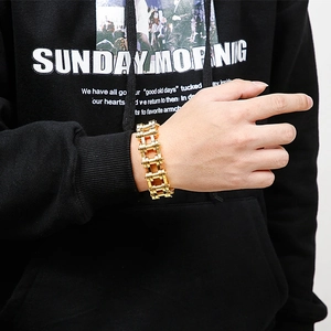 Macro shot of gold stainless steel bike chain bracelet with heavy hip hop style