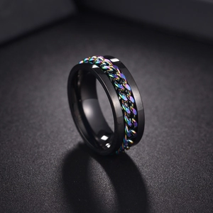 Macro detail of black stainless steel spinner ring with rainbow color rotating chain link