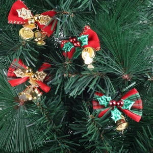 Mini Christmas bows with gold bells and berries on green pine branches for tree decoration