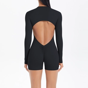 Detail of ruched peach-butt seam and oval back cutout on black yoga bodysuit
