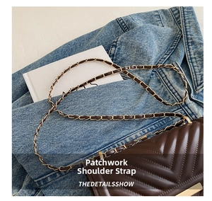 Detail of dark coffee quilted leather crossbody bag with gold chain strap on denim