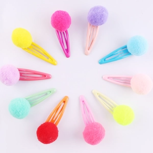 Close-up of colorful plush ball hair clips for girls in various vibrant candy colors