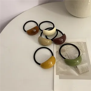 Detail of high-elasticity hair ties with resin bean charms in six earthy colors