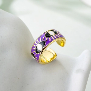 Detailed close-up of 18K gold-plated eye-shaped ring with purple enamel finish