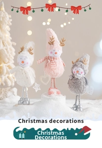 Detailed view of three plush Christmas snowmen with antlers in soft white, pink and gray