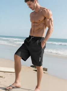 Men's quick-dry tactical beach shorts in black with gray drawstring by the sea