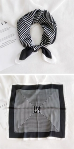 Flat lay and knotted display of black and white geometric silk square scarf with line patterns