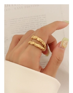 Macro detail of a 18k gold double-layered ring with hammered tin foil texture