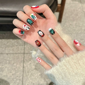 Cute Santa Christmas press-on nails featuring red and green festive cartoon patterns