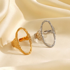 Hammered gold and silver oval open rings on premium silk background for a luxury look