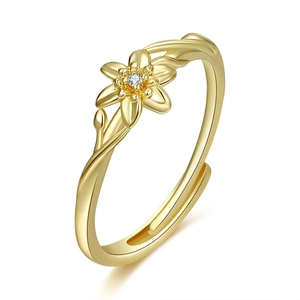 Detailed macro view of gold flower ring with center zircon and adjustable band