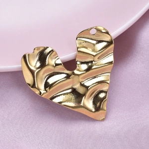 Vintage golden 304 stainless steel heart pendant with wrinkled texture on purple cloth