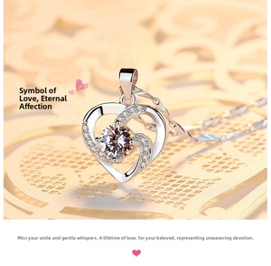Detailed view of silver heart pendant featuring a large center stone and pavé accents