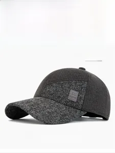 Detail of dark gray patchwork baseball cap showing textured tweed and MQWRID logo patch