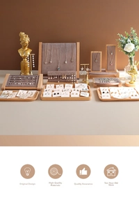 Macro shot of assorted jewelry displayed on grey velvet panels with solid wood bases