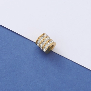 Detailed macro view of a gold hollow barrel bead with three rows of sparkling rhinestones